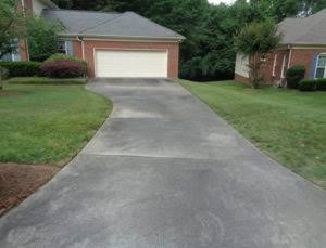 Driveway before pressure washing — stained and dirty